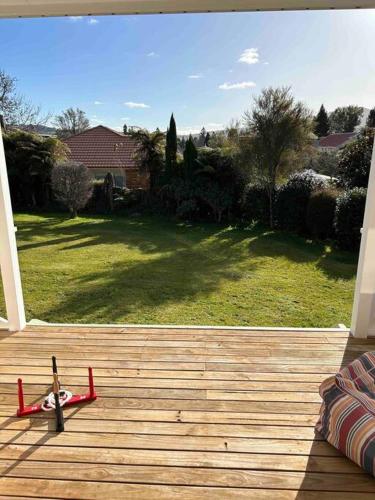 a red toy plane sitting on a wooden deck at Family Perfect, winter getaway, secure yard, parking, mountain bikes, arcade in Rotorua