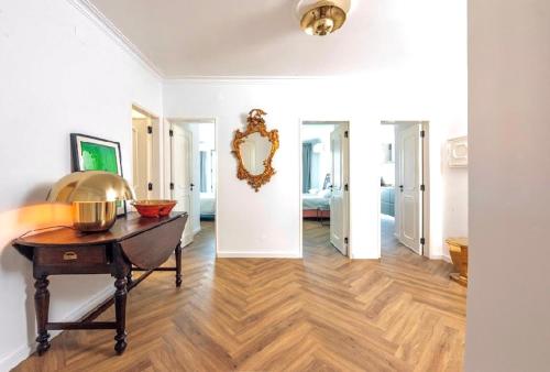 a living room with a table and a mirror at Elegant Apartment Overlooking Historic Loulé in Loulé