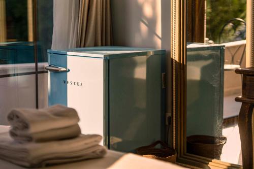 a blue and white box in front of a mirror at Lulu Inn Hotel in Cesme