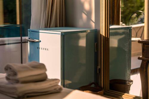 a blue and white box in front of a mirror at Lulu Inn Cesme in Çeşme