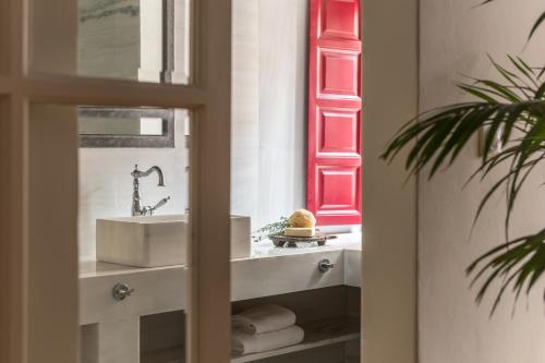 a bathroom with a sink and a mirror at FOS Hydra residence in Hydra