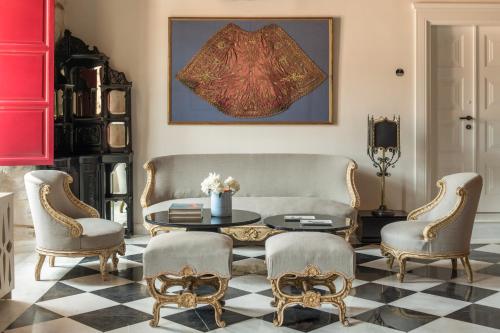 a living room with a table and chairs at FOS Hydra residence in Hydra