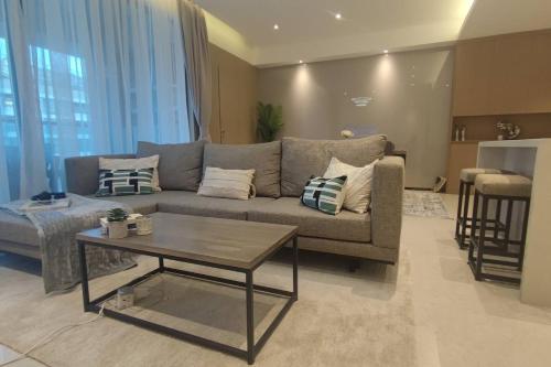 a living room with a couch and a table at GTC Posh Hideaway in Westlands in Nairobi