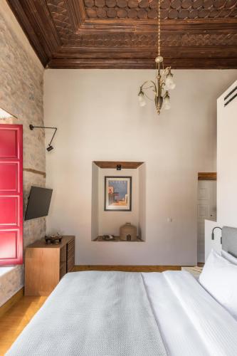a bedroom with a large bed with a wooden ceiling at FOS Hydra residence in Hydra