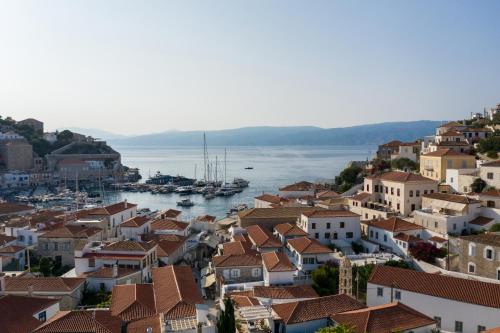a view of a town with boats in the water at FOS Hydra residence in Hydra