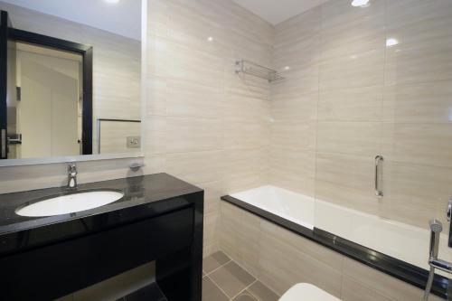 a bathroom with a sink and a bath tub at SHH - Funished Studio with Balcony in Damac Celestia, Dubai South Near Expo in Dubai