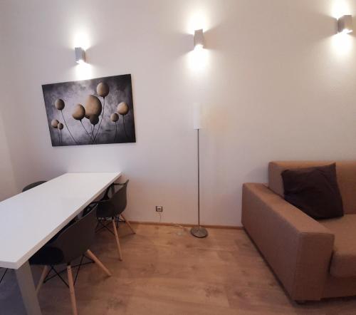a living room with a table and a couch at Residence Mariánská in České Budějovice