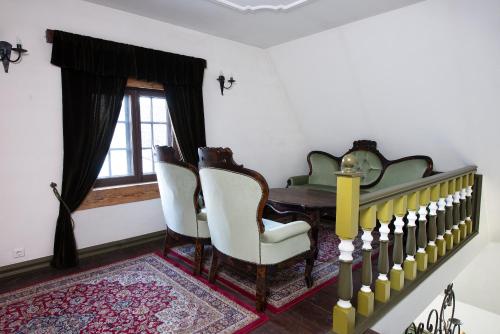 a dining room with a table and chairs and a window at St. Peterburg in Pärnu