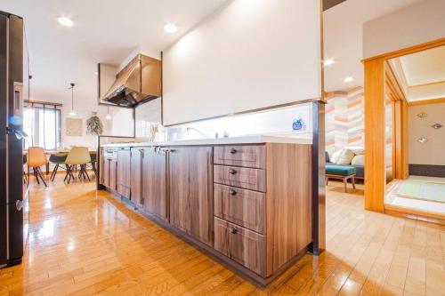 a kitchen with wooden cabinets in a room at THE BLAUBAUM TOYA in Lake Toya