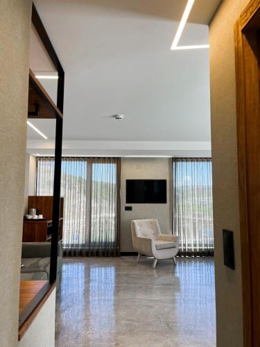 a living room with a chair and a television at Well Hotel & Spa in Maceira