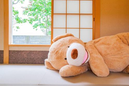 two teddy bears sitting on the floor in a room at THE BLAUBAUM TOYA in Lake Toya