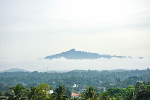 a view of a mountain obscured by a layer of clouds at Royal Retreat ,Kandy in Kandy