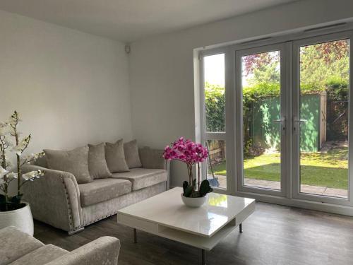 a living room with a couch and a coffee table at Modern, Stylish and Central Home in Manchester