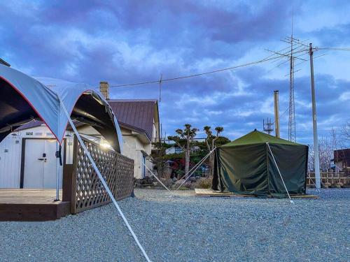 a couple of tents sitting in a parking lot at THE BLAUBAUM TOYA in Lake Toya