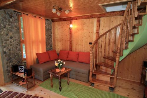 a living room with a couch and a staircase at Holiday Home Vesna in Brod na Kupi