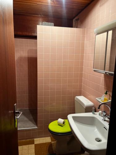 a bathroom with a sink and a toilet with a yellow stool at l'montagne 1650 in Courchevel