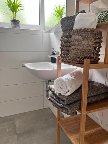 a bathroom with a sink and a towel rack at Charmantes Apartment in Offenburg
