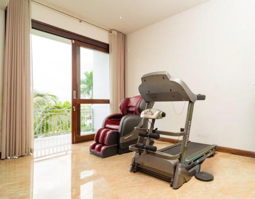 a gym with a treadmill and a chair in a room at Royal Retreat Kandy in Kandy