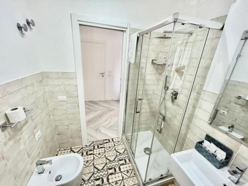 a bathroom with a shower and a toilet and a sink at Luisella in Gaeta