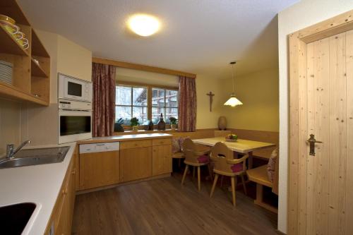 a kitchen with a table and a dining room at Urbanhof in Sölden