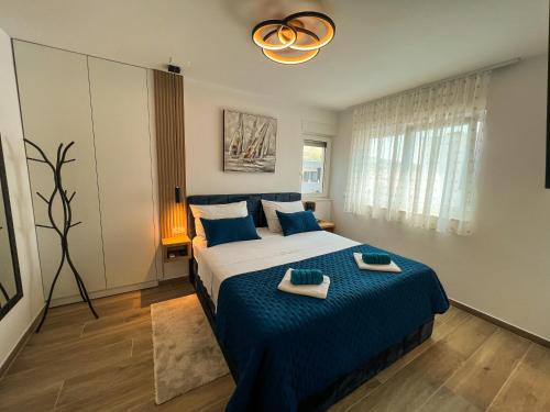a bedroom with a bed with two towels on it at Luxury penthouse SkyView in Trogir