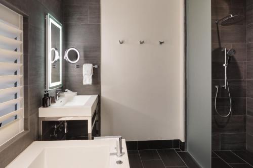 a bathroom with a white sink and a shower at HOTEL CERRO, Autograph Collection in San Luis Obispo