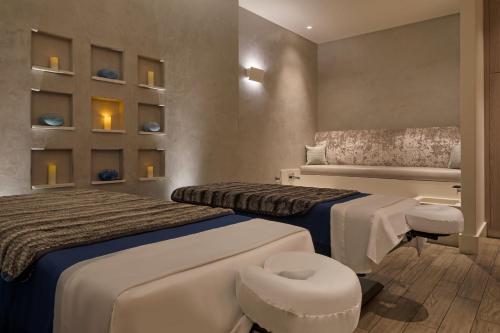 a hotel room with two beds and a chair at HOTEL CERRO, Autograph Collection in San Luis Obispo