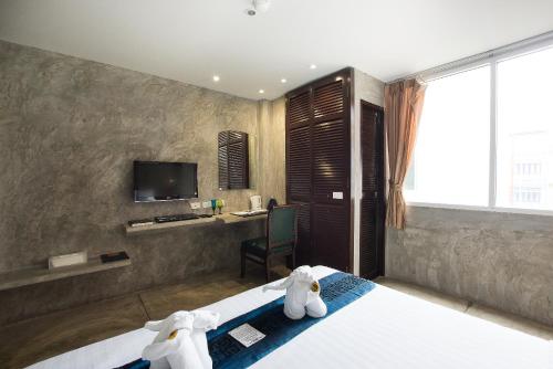 a bedroom with two polar bears sitting on a bed at Buddy Boutique Inn in Bangkok