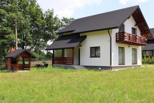a small white house with a black roof at Zen House Bran in Bran
