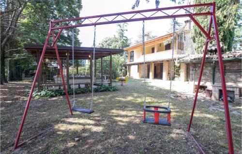 a swing set in the yard of a house at Amazing Home In Rivotorto Di Assisi in Passaggio Di Assisi