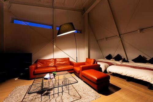 a room with a couch and a bed in a tent at MS STUDIO in Asahikawa