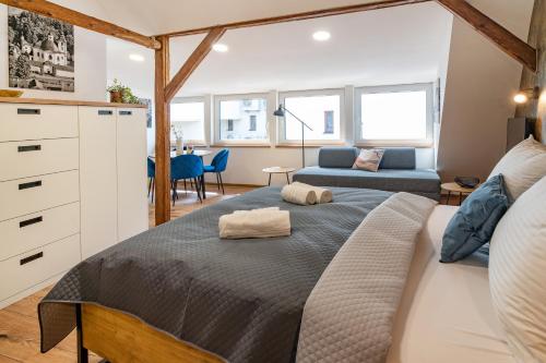 a bedroom with a bed and a living room at Hotel Smrž in Sepekov