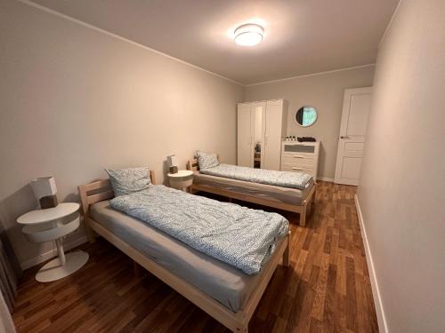 a room with two beds and a sink in it at Modern city center apartment in Sigulda
