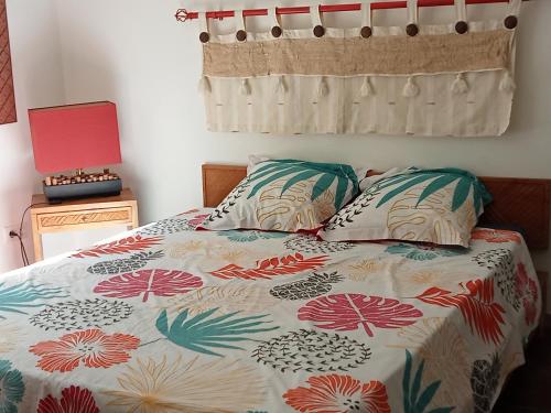 a bedroom with a bed and two pillows at Villa La Croisette in Sainte-Maxime