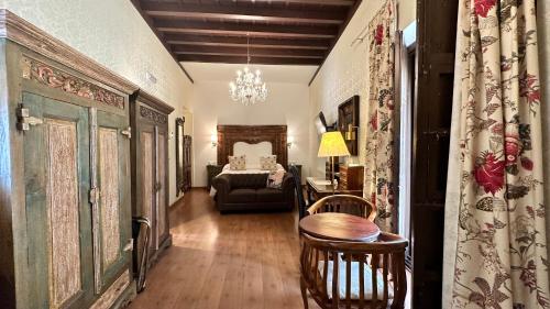 a living room with a bed and a table at El Rey Moro Hotel Boutique in Seville