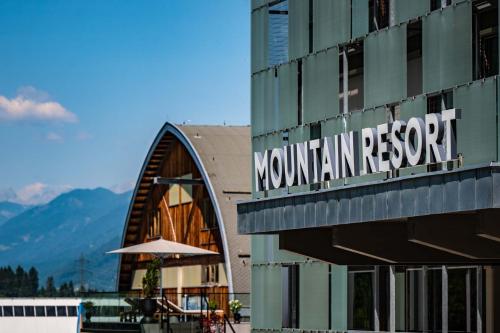 a mountain resort sign on the side of a building at Arena Franz Ferdinand Nassfeld in Tröpolach