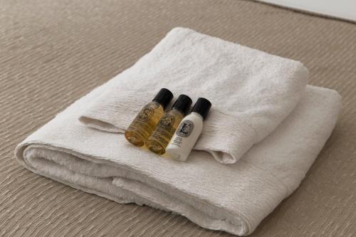 two bottles of essential oils sitting on a towel at Andros Moments Suites in Batsi