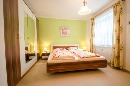 a bedroom with a bed and a large window at Apartment Renn in Uttendorf