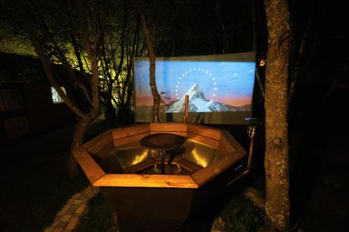 a wooden bathtub in front of a large screen at Garden Inn Resort Sevan in Sevan