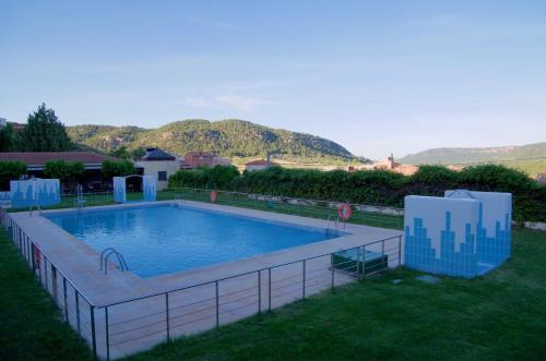a swimming pool with a fence around it at La Alquería in Ráfales