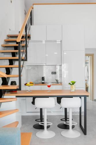 a kitchen with a wooden table and two stools at Villa Irene in Polychrono