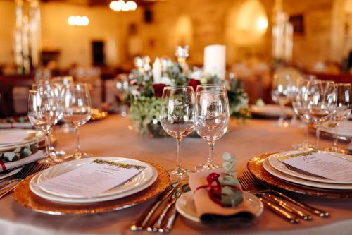 a table with plates and wine glasses on it at Chateau Purcari in Purcari