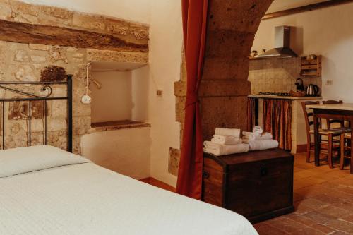 a bedroom with a bed with towels on a table at Dolce Vita Assedio in Pitigliano