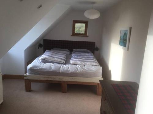 a bedroom with a bed in a attic at The Neuk Achmore Plockton in Stromeferry