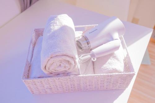 a basket with a hair dryer and a towel at 10min walk to Shinjuku YEoE-2 in Tokyo