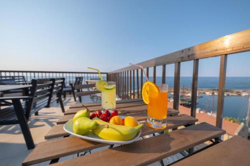 a plate of fruit on a table on a balcony at Kyrenia British Harbour Hotel in Kyrenia