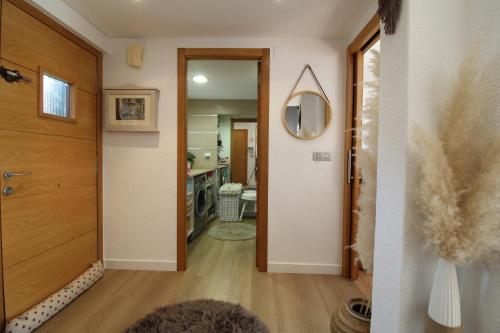 a hallway with a door leading to a kitchen at Chalet junto a la Ciudadela de Jaca in Jaca