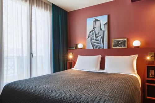 a bedroom with a large bed with red walls at Mercure Paris Tour Eiffel Pont Mirabeau in Paris