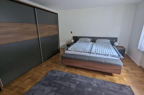 a bedroom with a large bed and a large closet at Ferienhaus Kusel Blick in Kusel