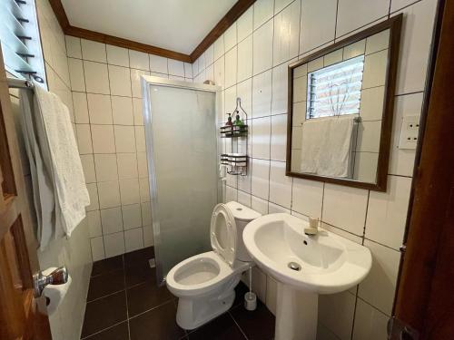 a bathroom with a toilet and a sink at Tipolo Beach Resort in Moalboal